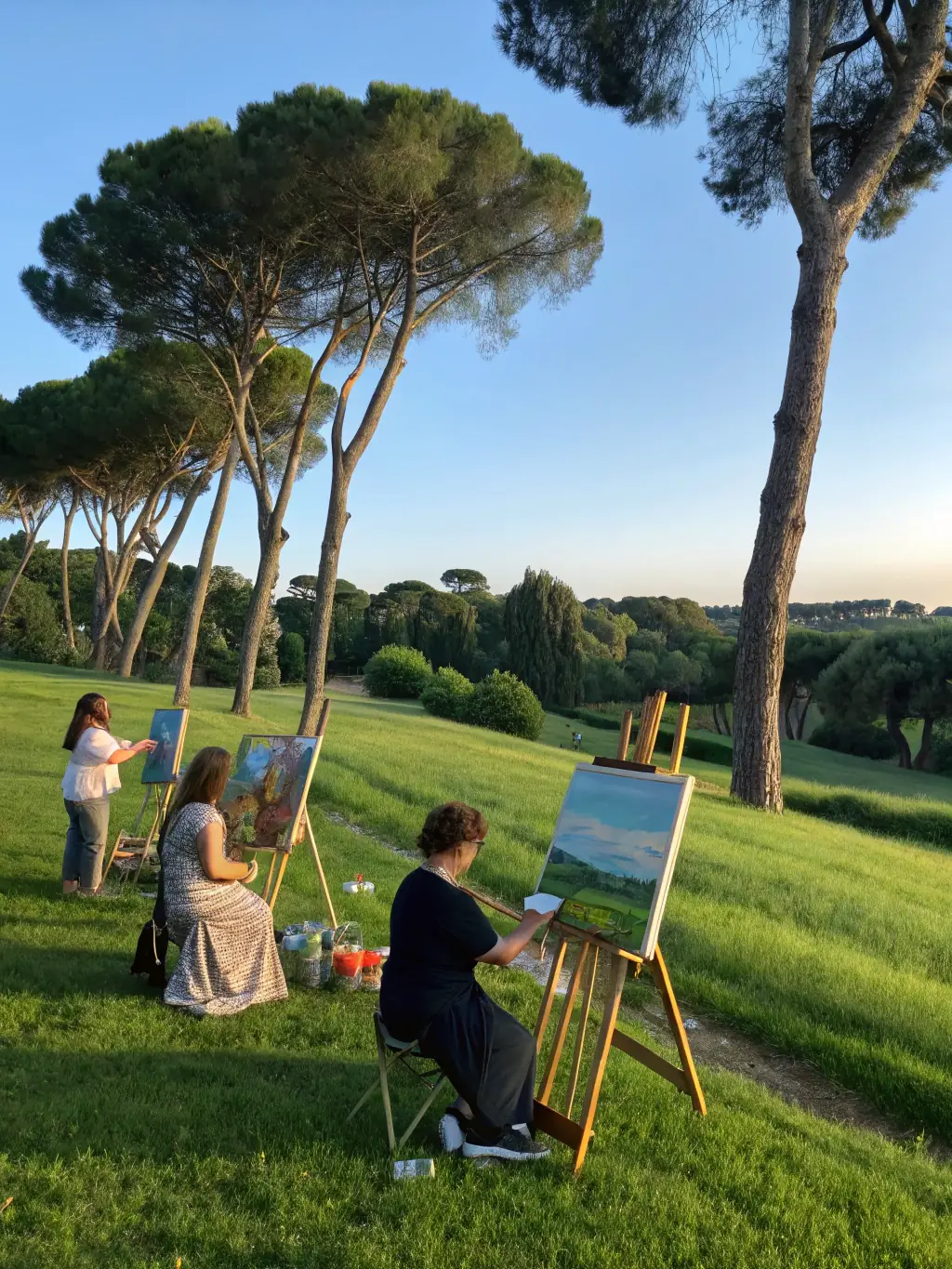 A photograph showing students from a local school participating in an ECO-led art education program, painting outdoors and learning about art techniques from a professional artist.